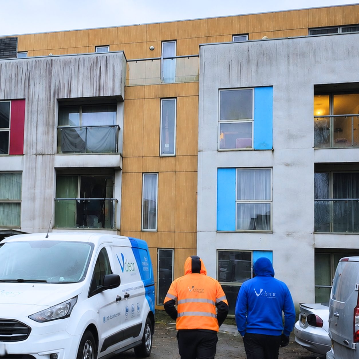 Vclear team arriving to clean a stained rendered building exterior